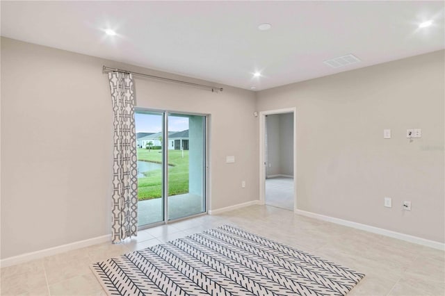 empty room with recessed lighting, visible vents, and baseboards