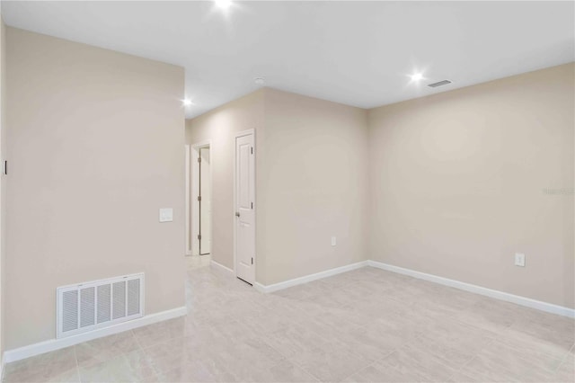 unfurnished room with recessed lighting, visible vents, and baseboards