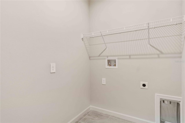 laundry area featuring laundry area, hookup for a washing machine, baseboards, and electric dryer hookup