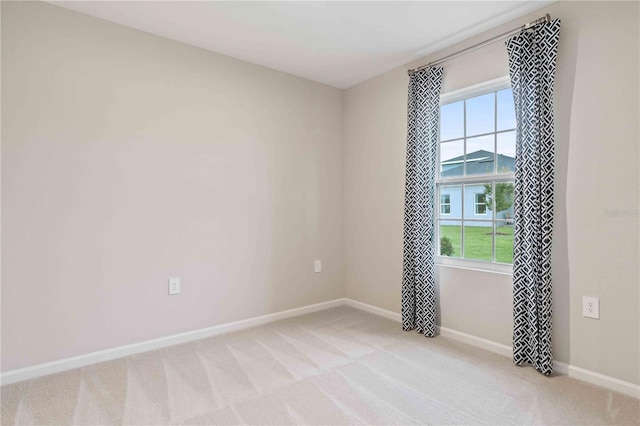 empty room with light carpet and baseboards