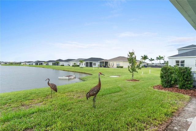 view of yard featuring a water view and a residential view