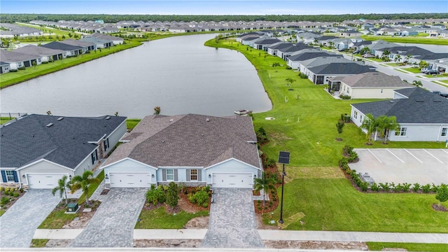 drone / aerial view featuring a residential view and a water view