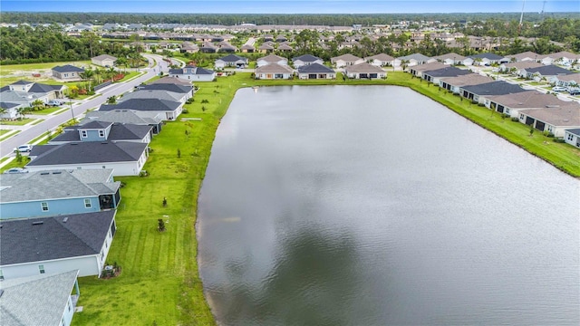 drone / aerial view featuring a residential view and a water view