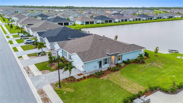 drone / aerial view featuring a water view and a residential view