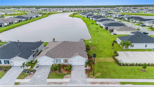 bird's eye view featuring a water view and a residential view