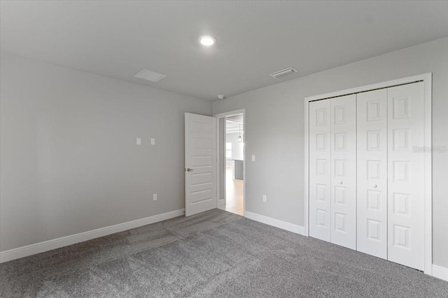 unfurnished bedroom featuring a closet and carpet flooring