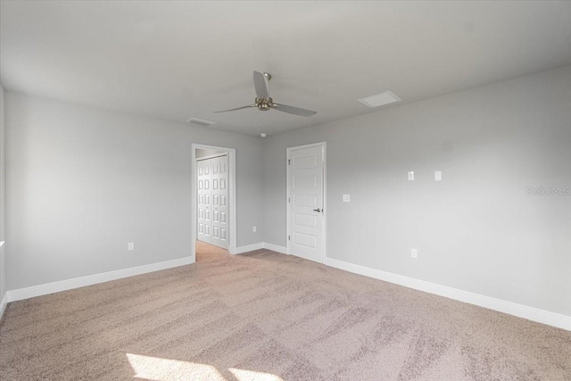 unfurnished room featuring ceiling fan and light colored carpet