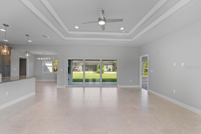 unfurnished living room with crown molding, ceiling fan, and a tray ceiling