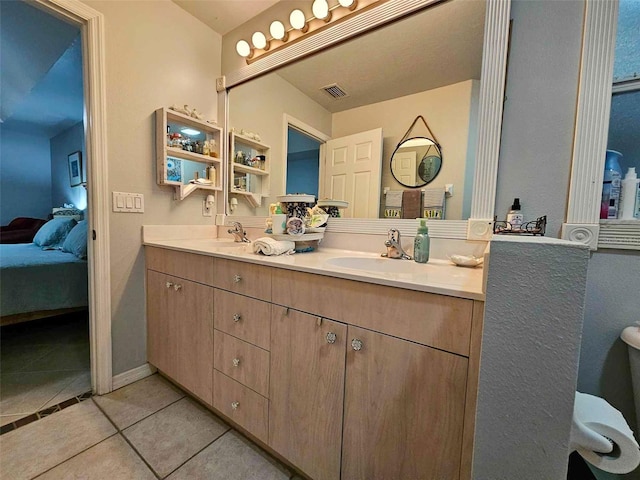 bathroom with vanity and tile patterned flooring