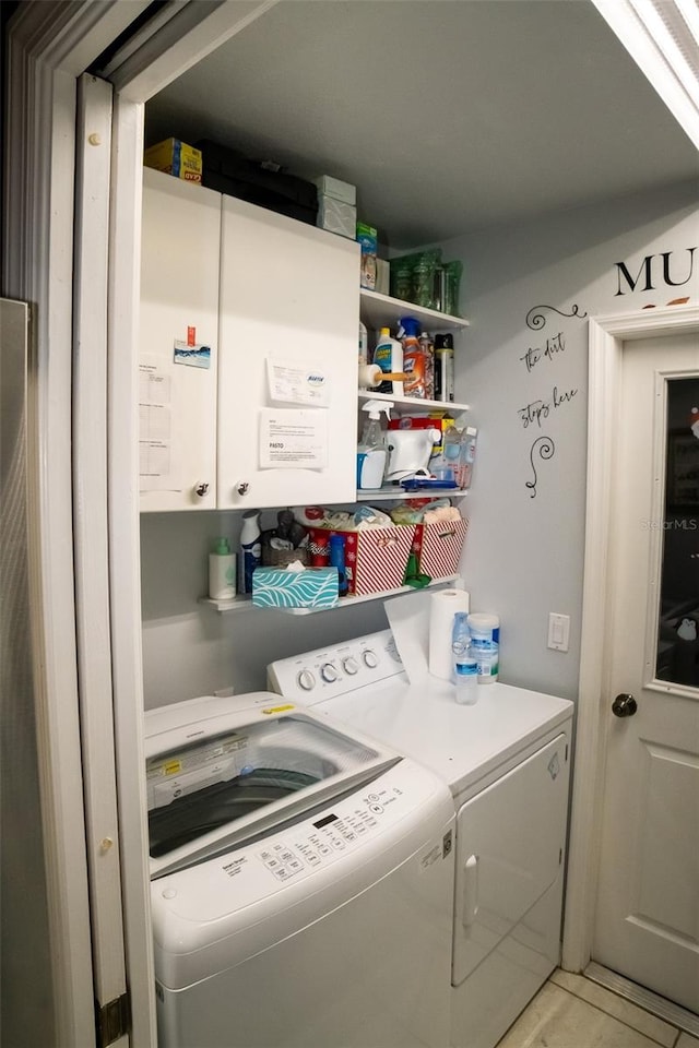 laundry room featuring cabinets and independent washer and dryer