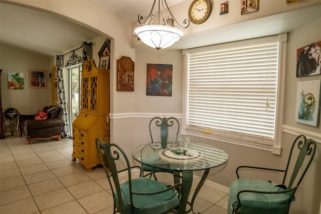 tiled dining room with vaulted ceiling