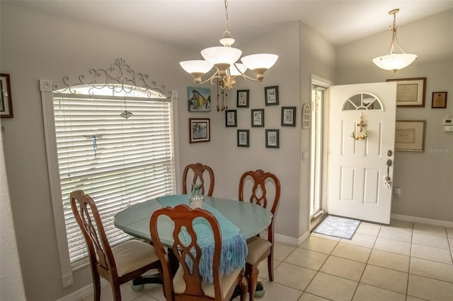 tiled dining area with vaulted ceiling and a notable chandelier