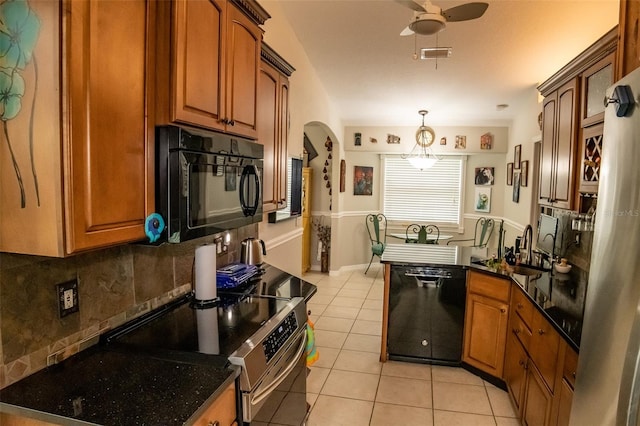 kitchen featuring black appliances, light tile patterned flooring, backsplash, pendant lighting, and ceiling fan