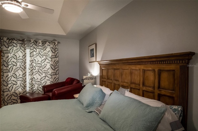 bedroom with a tray ceiling and ceiling fan