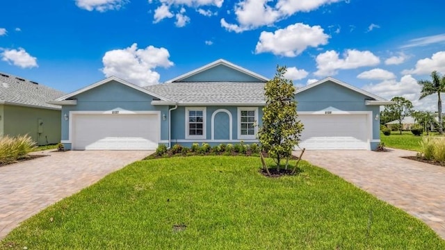 ranch-style house featuring a front lawn and a garage