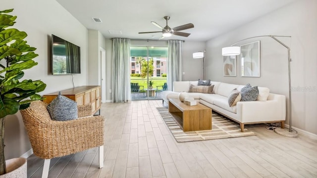 living room with light hardwood / wood-style floors and ceiling fan