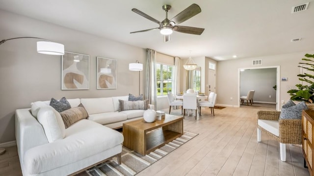 living room featuring light hardwood / wood-style floors and ceiling fan