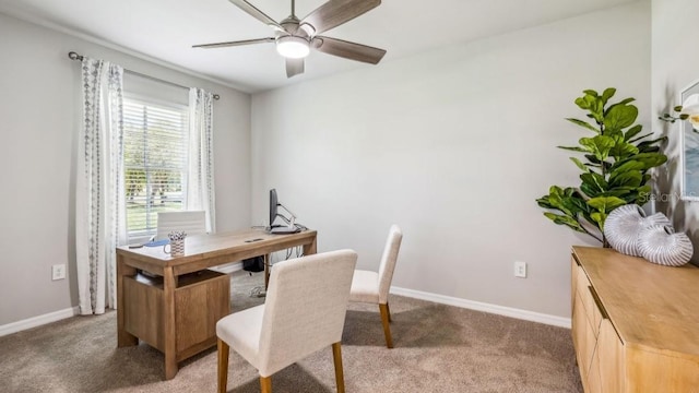 carpeted home office featuring ceiling fan