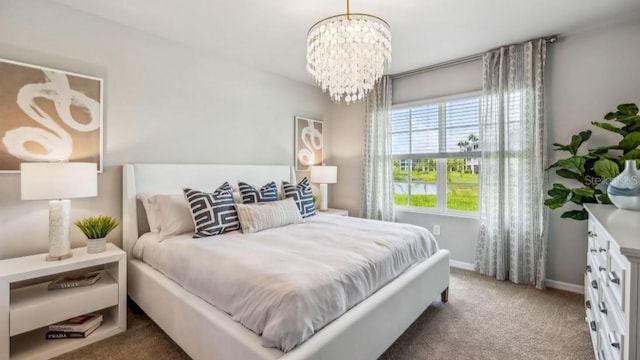 carpeted bedroom with a notable chandelier