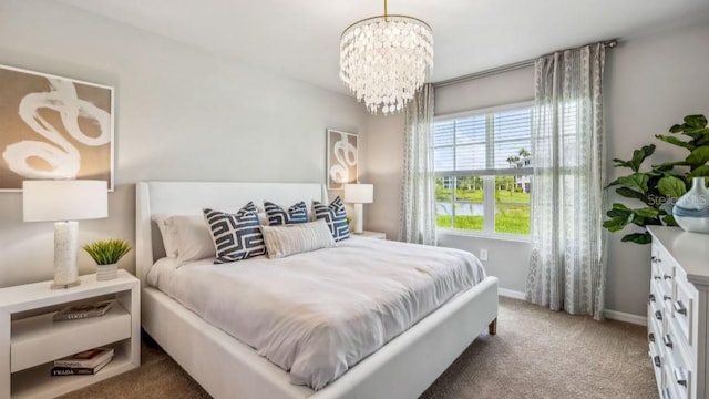 bedroom with carpet and a chandelier