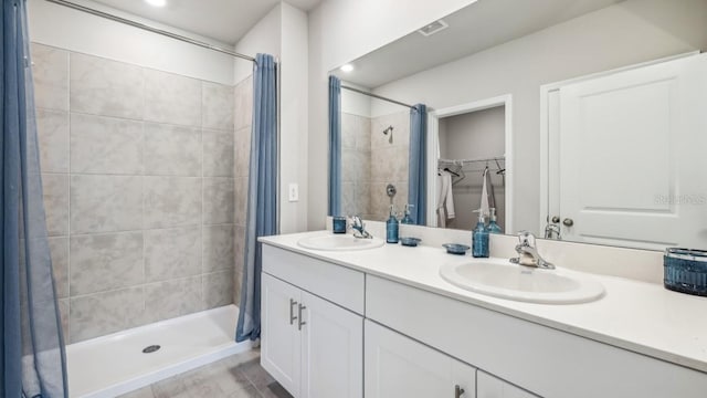 bathroom featuring curtained shower and vanity