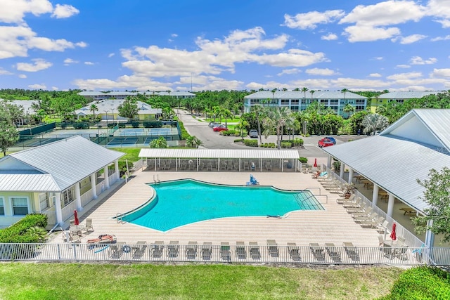 view of swimming pool featuring a lawn and a patio area