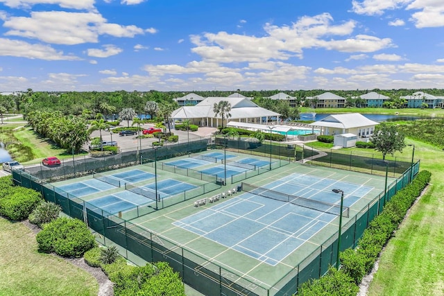 view of tennis court featuring a yard