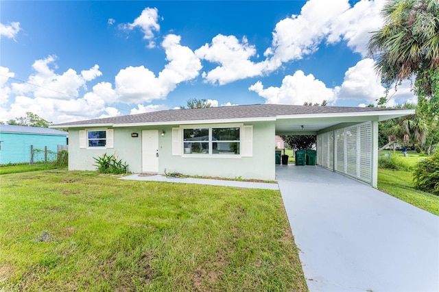 view of front of property with a front lawn and a carport