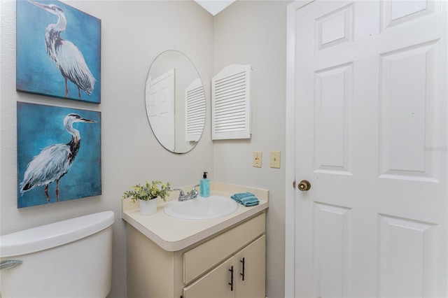 bathroom featuring vanity and toilet