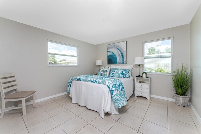 bedroom featuring light tile patterned floors and multiple windows