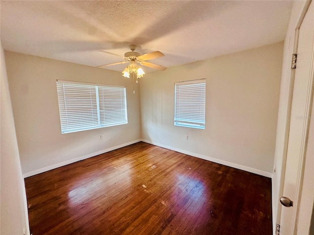 empty room featuring ceiling fan, a textured ceiling, baseboards, and wood finished floors