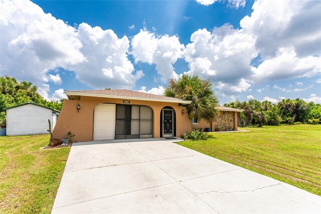 ranch-style home featuring a garage and a front yard