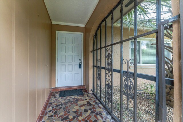 doorway with tile patterned floors and a healthy amount of sunlight