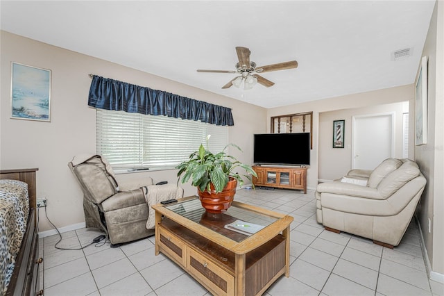 tiled living room with ceiling fan