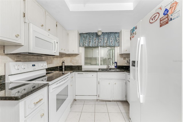 kitchen with backsplash, white cabinets, light tile patterned floors, sink, and white appliances