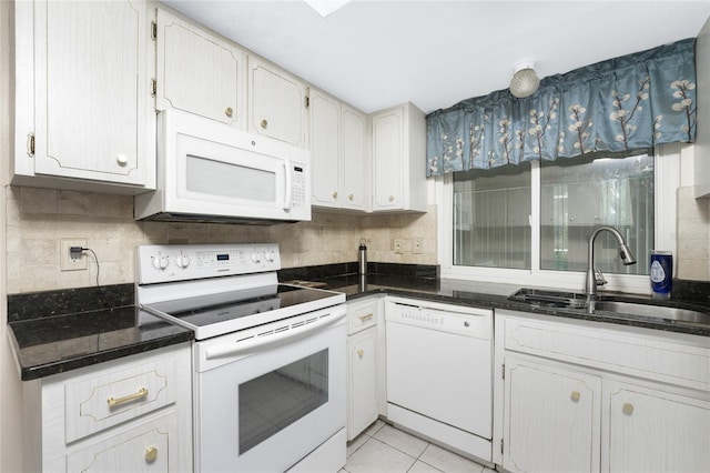 kitchen with backsplash, white cabinets, light tile patterned floors, sink, and white appliances