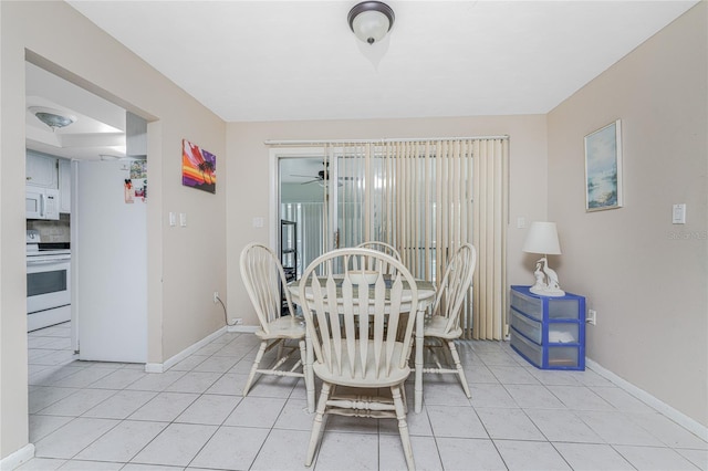 dining space featuring ceiling fan and light tile patterned flooring