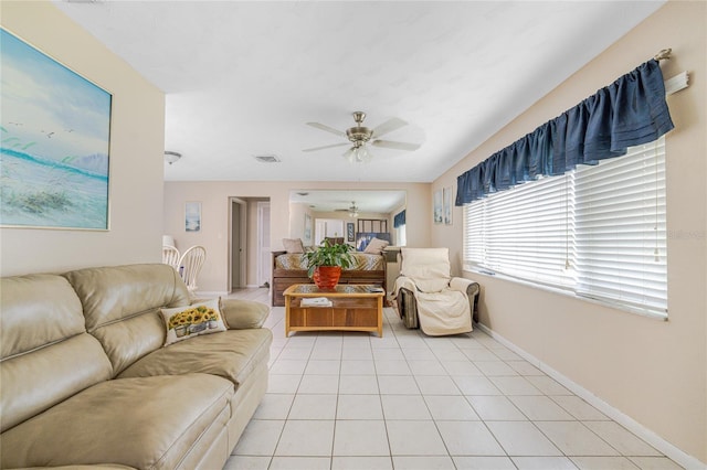 living room with ceiling fan and light tile patterned flooring