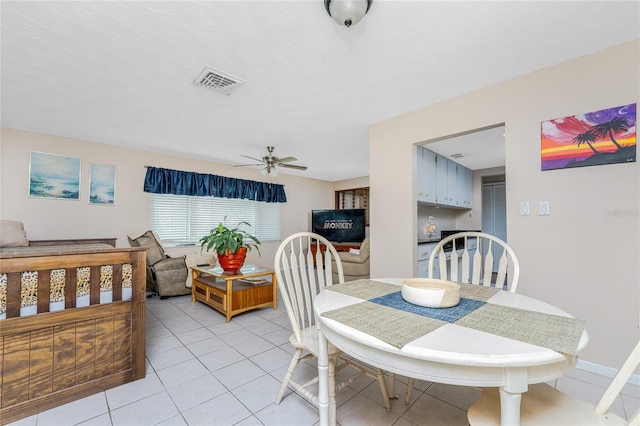 dining space featuring ceiling fan and light tile patterned floors