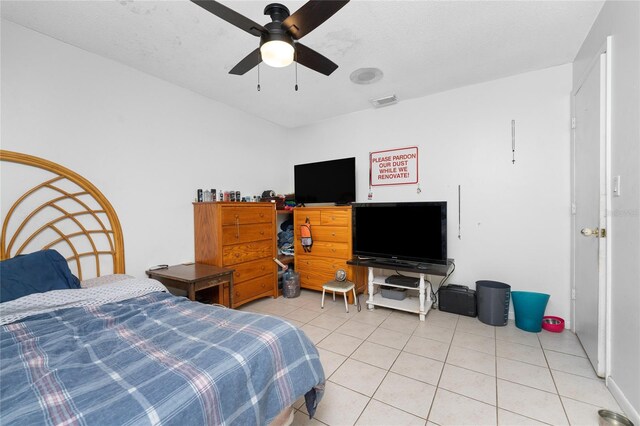 bedroom with ceiling fan and light tile patterned flooring