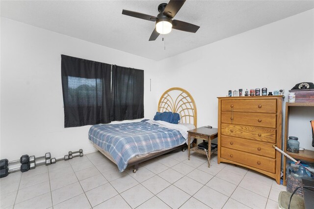 bedroom with ceiling fan and light tile patterned flooring