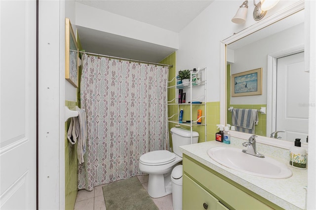 bathroom with tile patterned flooring, toilet, a textured ceiling, and vanity