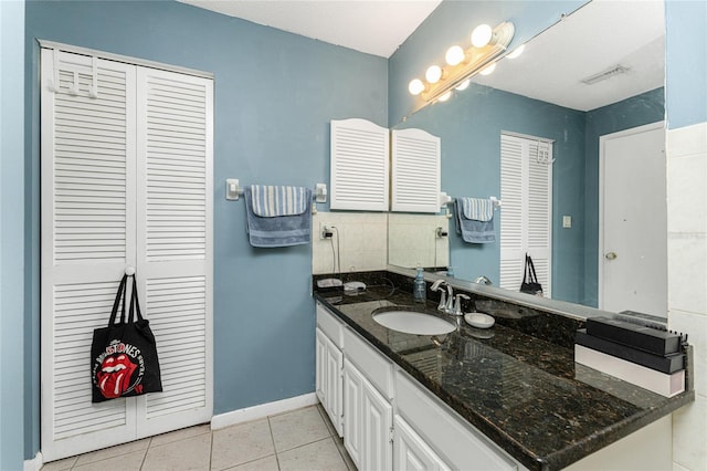 bathroom with tile patterned flooring and vanity