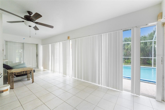 spare room featuring ceiling fan and light tile patterned floors