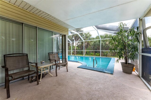 view of pool featuring a patio area and a lanai