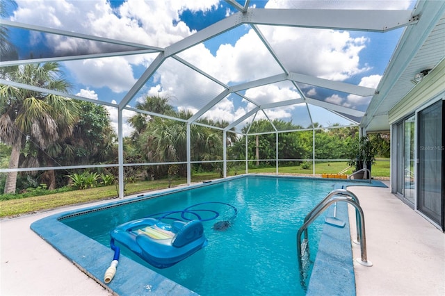 view of pool with glass enclosure