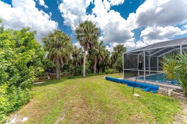 view of yard featuring glass enclosure