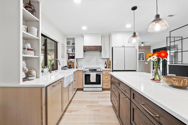 kitchen featuring electric stove, sink, premium range hood, white refrigerator, and white cabinets