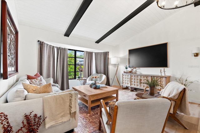 living room with hardwood / wood-style flooring, lofted ceiling with beams, and a notable chandelier