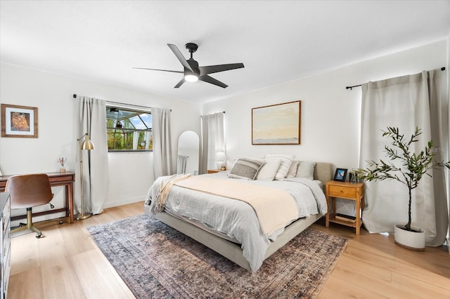 bedroom with ceiling fan and light wood-type flooring